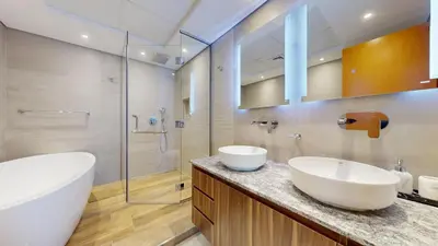 a bathroom with two sinks and a shower at Vacationer I Hidden Gem in Marina l 3 Bedroom I Yacht Views, Free Pool, Gym & Wi-Fi in Dubai