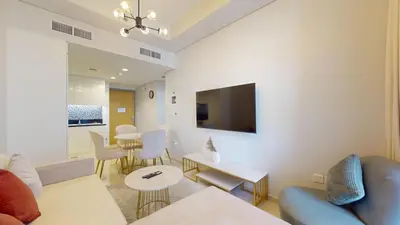 a living room with a couch and a tv at Aykon Tower - Calm One Bed in Business Bay in Dubai