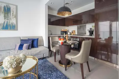 a living room with a couch and a table at Frank Porter - Damac Majestine in Dubai