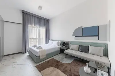 a bedroom with a bed and a couch at Brand New Studio 15 mins drive from Business Bay in Dubai