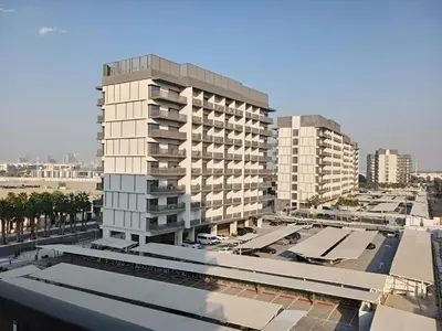 an aerial view of a tall building with buildings at Brand New Studio 15 mins drive from Business Bay in Dubai