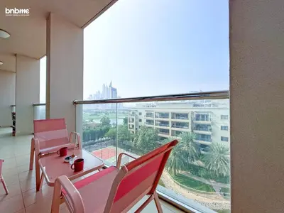 a room with chairs and a table and a large window at bnbmehomes - Golf Tower 1 in Dubai
