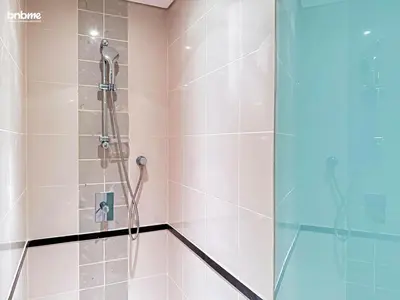 a bathroom with a shower with a glass door at bnbmehomes - Golf Tower 1 in Dubai