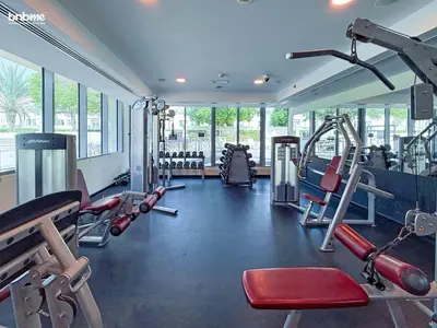 a gym with several treadmills and machines in it at bnbmehomes - Golf Tower 1 in Dubai
