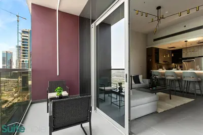 an apartment with a balcony with a view of the city at Elegant 1-Bedroom with Stunning Lake View in JLT in Dubai