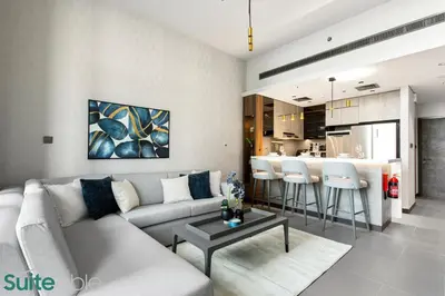a living room with a couch and a table at Elegant 1-Bedroom with Stunning Lake View in JLT in Dubai