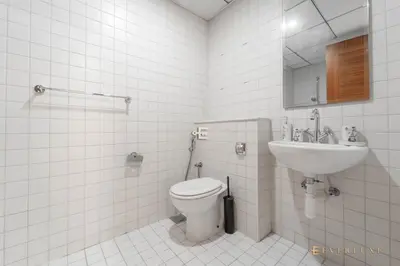 a bathroom with a toilet and a sink at Beautiful & Spacious 3 Bedroom Wmaids In Marina in Dubai