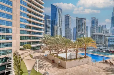 an aerial view of a city with a pool and buildings at Beautiful & Spacious 3 Bedroom Wmaids In Marina in Dubai