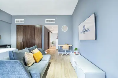 a living room with blue walls and a blue couch at Stylish & Compact Home in the Heart of the JVC in Dubai