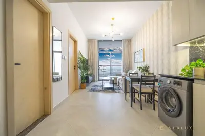 a kitchen and dining room with a washing machine at 1-bedroom Apartment In Binghatti Avenue in Dubai