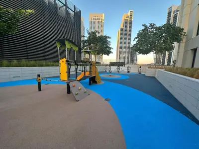 a playground in a city with tall buildings at Park View Stay at Creek Horizon in Dubai