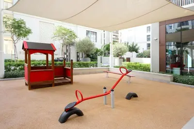 a group of red scissors sitting in front of a building at Breeze haven residences- 2BHK brand new furnished apartment in Dubai