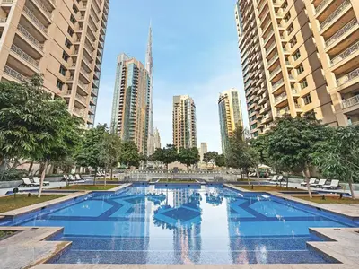 a large swimming pool in a city with tall buildings at The Boulevard Suite Luxury near Burj Khalifa in Dubai