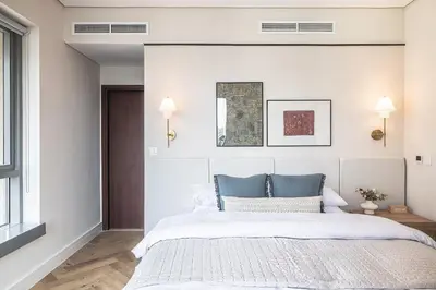 a bedroom with a large bed with blue pillows at The Boulevard Suite Luxury near Burj Khalifa in Dubai