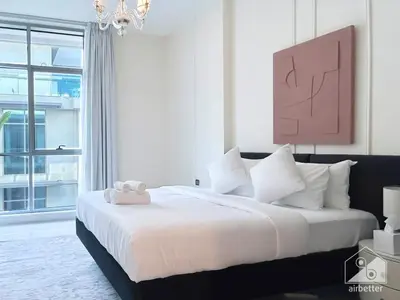 a bedroom with a bed with a teddy bear on it at Your Perfect Meydan Getaway 1B Polo Residence C3 in Dubai