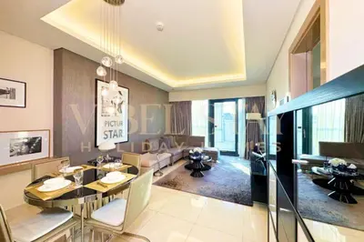 a dining room and living room with a dining table at Prime 1BR Location Minutes to Burj Dubai Mall by Vibel in Dubai