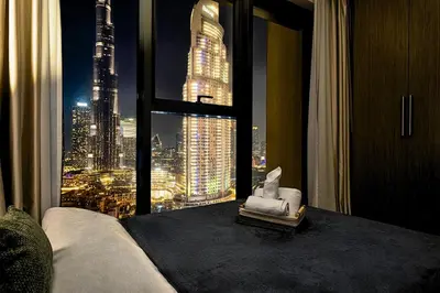 a room with a view of a city from a window at Luxury At The Top- Iconic Burj Views-Dubai Mall Access 2BR by Maxx Value Homes in Dubai