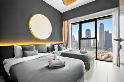 a hotel room with two beds and a large window at Luxury At The Top- Iconic Burj Views-Dubai Mall Access 2BR by Maxx Value Homes in Dubai