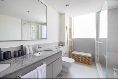 a bathroom with a sink and a toilet and a mirror at Apartment Downtown Dubai in Dubai