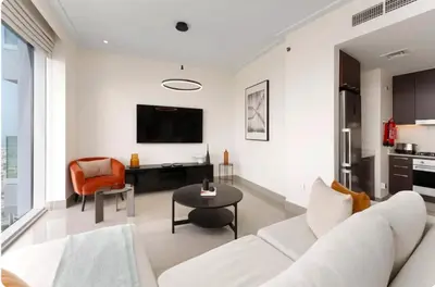 a living room with a white couch and a table at Penthouse Downtown Dubai in Dubai