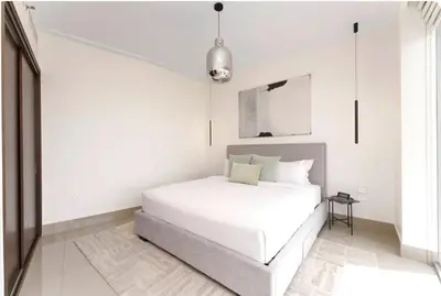 a white bedroom with a large white bed in it at Penthouse Downtown Dubai in Dubai
