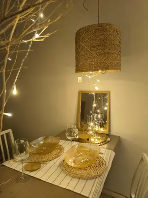 a table with plates and glasses and a mirror at Stylish Boutique Loft Duplex, Near Circle Mall, Balcony, Fast WiFi, 2 Pools and Gym in Dubai