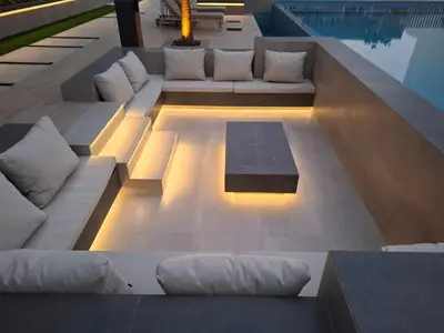 a living room with a couch and a pool at Stylish Boutique Loft Duplex, Near Circle Mall, Balcony, Fast WiFi, 2 Pools and Gym in Dubai