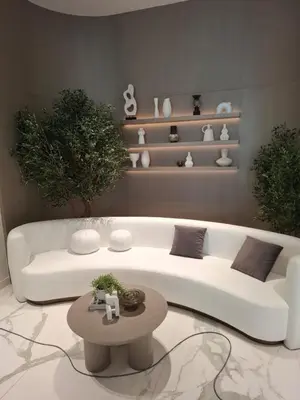 a living room with a white couch and a table at Stylish Boutique Loft Duplex, Near Circle Mall, Balcony, Fast WiFi, 2 Pools and Gym in Dubai