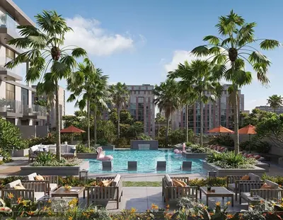 an outdoor pool with chairs and palm trees and buildings at Stylish Boutique Loft Duplex, Near Circle Mall, Balcony, Fast WiFi, 2 Pools and Gym in Dubai