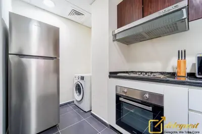 a kitchen with a stainless steel stove and refrigerator at Prestine 3BR Villa in DH2 by deleguest in Dubai