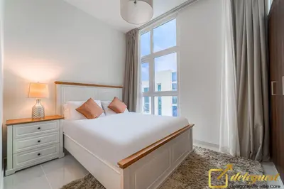 a bedroom with a large white bed and a window at Prestine 3BR Villa in DH2 by deleguest in Dubai