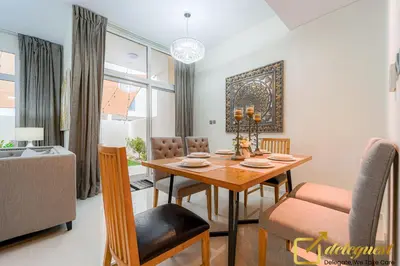 a dining room with a table and chairs at Prestine 3BR Villa in DH2 by deleguest in Dubai