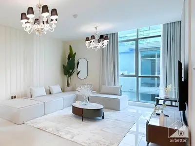 a living room with white furniture and a large window at Stylish Escape in Meydan 1B Polo Residence C3 in Dubai