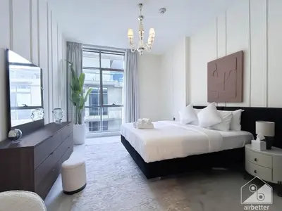 a bedroom with a large bed and a large window at Stylish Escape in Meydan 1B Polo Residence C3 in Dubai