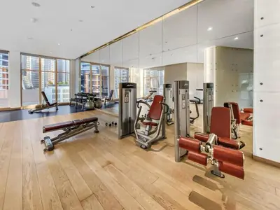 a gym with several exercise equipment in a room at Vogue Business Bay Damac Maison Prive near Burj Khalifa and Dubai Mall, Studio Apartment with Canal and City View, Access to all Amenities in Dubai
