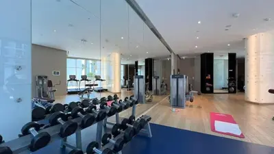 a gym with rows of chairs in a room at Vogue Business Bay Damac Maison Prive near Burj Khalifa and Dubai Mall, Studio Apartment with Canal and City View, Access to all Amenities in Dubai