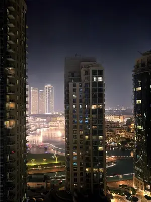 a view of a city at night with tall buildings at Near Burj Khalifa, Dubai Fountain view, Dubai Mall in 10 mins walk in Dubai