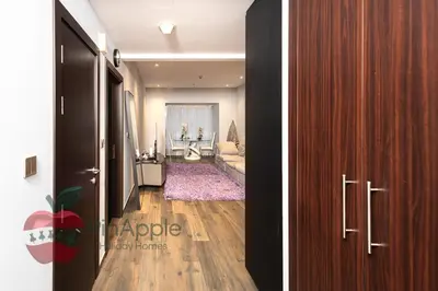 two pictures of a hallway with a living room at Sea and Dubai Ain view Close to Private Beach in Dubai