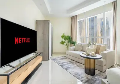 a living room with a tv and a couch at Spectacular Studio & 1 Bedroom Units By Costa close to metro in Dubai