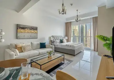 a living room with a couch and a table at Spectacular Studio & 1 Bedroom Units By Costa close to metro in Dubai