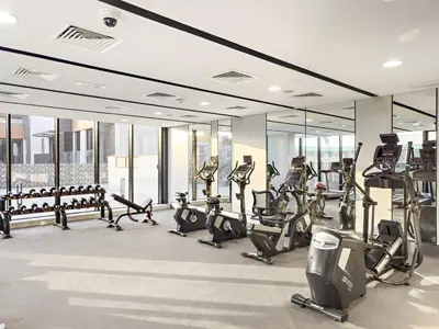 a gym with treadmills and ellipticals in a building at Studio Dubai, Cozy Luxury Stay Near Downtown Dining Shopping & Leisure in Dubai
