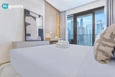 a bedroom with a white bed with a large window at HiGuests - Modern & Stylish 1BR Apt - Near Business Bay Metro in Dubai