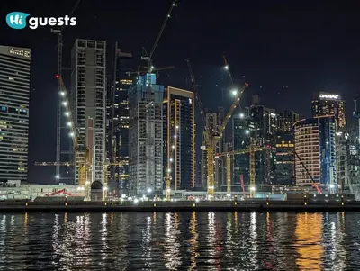 a night view of a large city with buildings at HiGuests - Modern & Stylish 1BR Apt - Near Business Bay Metro in Dubai