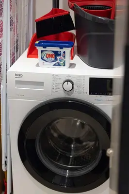 a washing machine with dishes on top of it at Modern 1-Bedroom Apartment with Stunning Burj Khalifa and city Views in Dubai