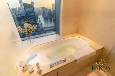 a bath tub in a bathroom with a window at The Captivating in Dubai