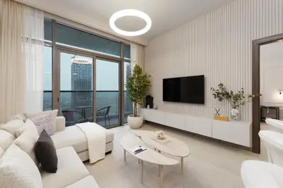a living room with a white couch and a tv at Maison Privee - Modern Living with Premium Amenities close to Marina in Dubai