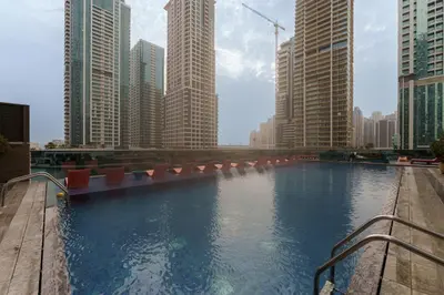a large pool of water in a city with tall buildings at Maison Privee - Modern Living with Premium Amenities close to Marina in Dubai