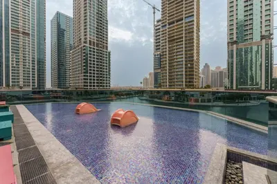 a swimming pool in a city with tall buildings at Maison Privee - Modern Living with Premium Amenities close to Marina in Dubai