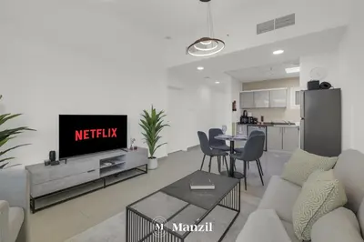 a living room with a tv and a kitchen at 1BR Apartment in JLT 2km to JBR Beach & Blue Waters Dubai in Dubai