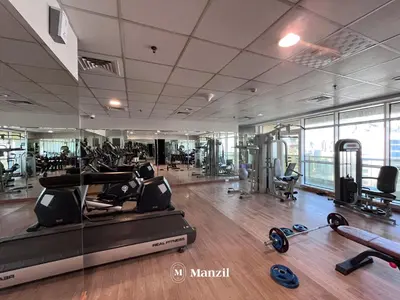 a gym with treadmills and exercise equipment in a building at 1BR Apartment in JLT 2km to JBR Beach & Blue Waters Dubai in Dubai